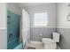 Classic bathroom featuring a blue-tile shower and gray-painted walls with a decorative shower curtain at 3941 Pin Oaks St, Sarasota, FL 34232