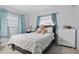 Cozy bedroom with two windows and light blue curtains, and a comfortable bed at 3941 Pin Oaks St, Sarasota, FL 34232