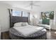 Bright bedroom featuring a unique round bed with an upholstered headboard and a view to the window at 3941 Pin Oaks St, Sarasota, FL 34232