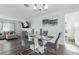 Open-concept dining area with modern table, chairs and television, seamlessly flowing from the living area at 3941 Pin Oaks St, Sarasota, FL 34232