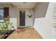 Close-up of the home's front door with tiled walkway, lovely plants and a warm welcome mat at 3941 Pin Oaks St, Sarasota, FL 34232