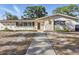Charming single-story home with decorative stone and a well-manicured front yard and walkway at 3941 Pin Oaks St, Sarasota, FL 34232