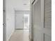 Hallway with a front door and textured privacy window plus a white closet door for storage at 3941 Pin Oaks St, Sarasota, FL 34232