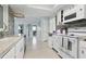 Bright kitchen featuring granite countertops, mosaic backsplash, white appliances and an open layout at 3941 Pin Oaks St, Sarasota, FL 34232