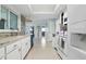 Bright kitchen featuring granite countertops, mosaic backsplash, white appliances and an open layout at 3941 Pin Oaks St, Sarasota, FL 34232