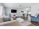 Spacious living area blending seamlessly into the dining space, with modern decor and a large television at 3941 Pin Oaks St, Sarasota, FL 34232