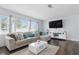 Cozy living room featuring modern furnishings, wood flooring and a stylish sectional sofa at 3941 Pin Oaks St, Sarasota, FL 34232
