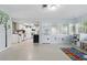 Playroom space featuring a colorful rug, playful wall decor, and a connected kitchen at 3941 Pin Oaks St, Sarasota, FL 34232