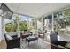 Enclosed sunroom featuring wicker furniture, neutral carpeting, and natural views at 3941 Pin Oaks St, Sarasota, FL 34232