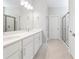 Bright bathroom featuring double sinks, quartz countertop, and sleek finishes and framed glass shower at 4008 Antelope Ter, North Port, FL 34286