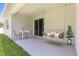 Inviting patio with swing, table, and seating for outdoor relaxation at 4008 Antelope Ter, North Port, FL 34286