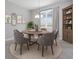 Elegant dining room with a round table, six chairs, and a stylish bookshelf at 4008 Antelope Ter, North Port, FL 34286