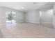 Open living area featuring tile flooring, sliding glass doors to a backyard and natural light at 4008 Antelope Ter, North Port, FL 34286