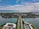Scenic aerial view showing a road stretching towards the ocean, flanked by residential areas at 4307 Camino Real, Sarasota, FL 34231