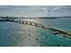 Aerial view of a bridge spanning a sparkling waterway with several boats and waterfront community at 4307 Camino Real, Sarasota, FL 34231