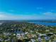 A beautiful aerial view of a waterfront community and blue-roofed home in the distance at 4307 Camino Real, Sarasota, FL 34231