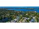 Aerial view of blue-roofed home in waterfront community, with views of the bay and skyline at 4307 Camino Real, Sarasota, FL 34231