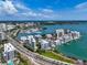 Scenic aerial shot of waterfront property with boat docks, condos and winding roads at 4307 Camino Real, Sarasota, FL 34231