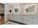 Bathroom featuring a double vanity with modern fixtures and great lighting at 4307 Camino Real, Sarasota, FL 34231
