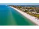 Beautiful aerial view of beachfront properties, featuring the pristine sands and azure waters of the ocean at 4307 Camino Real, Sarasota, FL 34231