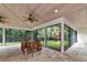 Enjoy the views of the lush backyard while dining in this spacious screened in patio with ceiling fans at 4307 Camino Real, Sarasota, FL 34231