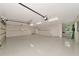 Spacious 3 car garage with epoxy floors, utility sink, overhead lighting and shelving at 4307 Camino Real, Sarasota, FL 34231