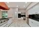 Modern Kitchen featuring black countertops, white cabinetry, and stainless steel appliances at 4307 Camino Real, Sarasota, FL 34231