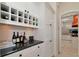 Bright kitchen area with wine storage and black granite countertops with convenient access to the main kitchen at 4307 Camino Real, Sarasota, FL 34231