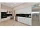 Spacious kitchen features white cabinetry, stainless steel appliances, and black countertops at 4307 Camino Real, Sarasota, FL 34231