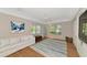 Comfortable living room featuring a sofa, area rug and natural light at 4307 Camino Real, Sarasota, FL 34231