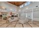 Expansive living space with kitchen and dining area featuring travertine floors and cathedral ceilings at 4307 Camino Real, Sarasota, FL 34231