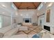 Bright living room with cathedral ceilings, travertine floors and built-in shelving at 4307 Camino Real, Sarasota, FL 34231