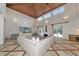 Spacious living room boasts soaring ceilings, travertine floors, and a cozy fireplace at 4307 Camino Real, Sarasota, FL 34231