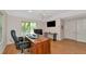 Well-lit office with hardwood floors, neutral walls, and a ceiling fan at 4307 Camino Real, Sarasota, FL 34231