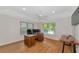 Well-lit office with hardwood floors, neutral walls, and a ceiling fan at 4307 Camino Real, Sarasota, FL 34231