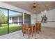 Covered patio with dining table and chairs, complete with an outdoor kitchen perfect for entertaining at 4307 Camino Real, Sarasota, FL 34231