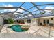 Backyard oasis featuring screened-in pool with an attached spa and large deck at 4307 Camino Real, Sarasota, FL 34231