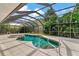 The pool and spa are surrounded by beautiful tropical landscaping in the backyard at 4307 Camino Real, Sarasota, FL 34231