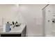 Bathroom with double sinks, modern fixtures, and a shower featuring a tiled enclosure at 4505 Dusky Dawn Ln, Palmetto, FL 34221