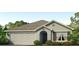 Charming single-story home with a two-car garage, landscaped front yard, and a classic architectural design at 4505 Dusky Dawn Ln, Palmetto, FL 34221
