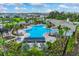 Community pool featuring inviting blue water, pergola covered lounge areas, and lush landscaping with palm trees at 4505 Dusky Dawn Ln, Palmetto, FL 34221