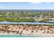 An aerial view showcasing the property's prime location near a river and lush landscape, with clear skies above at 4717 Lemon Bay Dr, Venice, FL 34293