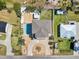Aerial view showcasing a home, pool, yard, and circular driveway at 4717 Lemon Bay Dr, Venice, FL 34293