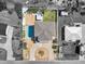 Aerial view of a home and pool, surrounded by gravel, mature trees and bordered by a fence at 4717 Lemon Bay Dr, Venice, FL 34293