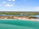 A high angle aerial view showcasing the property's proximity to the beach and clear blue ocean waters at 4717 Lemon Bay Dr, Venice, FL 34293
