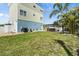 Backyard with a green lawn, landscaping, and a charming pergola-covered hot tub for outdoor relaxation at 4717 Lemon Bay Dr, Venice, FL 34293