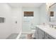 Modern bathroom features neutral tones, a single sink vanity, and a tiled shower at 4717 Lemon Bay Dr, Venice, FL 34293