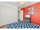 Well-lit bedroom features an accent wall, closet, and decorative accents at 4717 Lemon Bay Dr, Venice, FL 34293