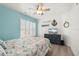Comfortable bedroom featuring shuttered window and beachy decor at 4717 Lemon Bay Dr, Venice, FL 34293
