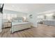 Spacious bedroom boasts wood floors, plantation shutters, and an attached bathroom at 4717 Lemon Bay Dr, Venice, FL 34293